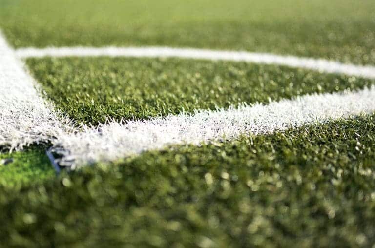 Close-up of lines drawn on a football field.