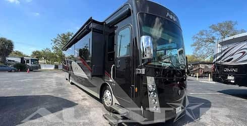 RV Rental: 40' Aria by Thor - Exterior view of entryway with slides extended