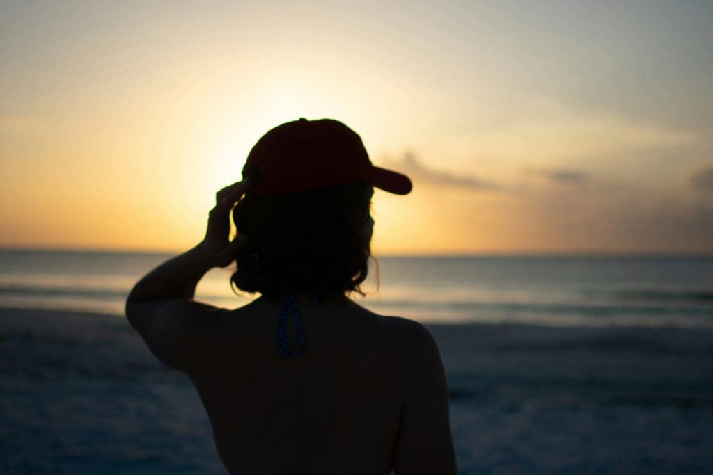 Person watching the sunset on a beach in Clearwater, FL