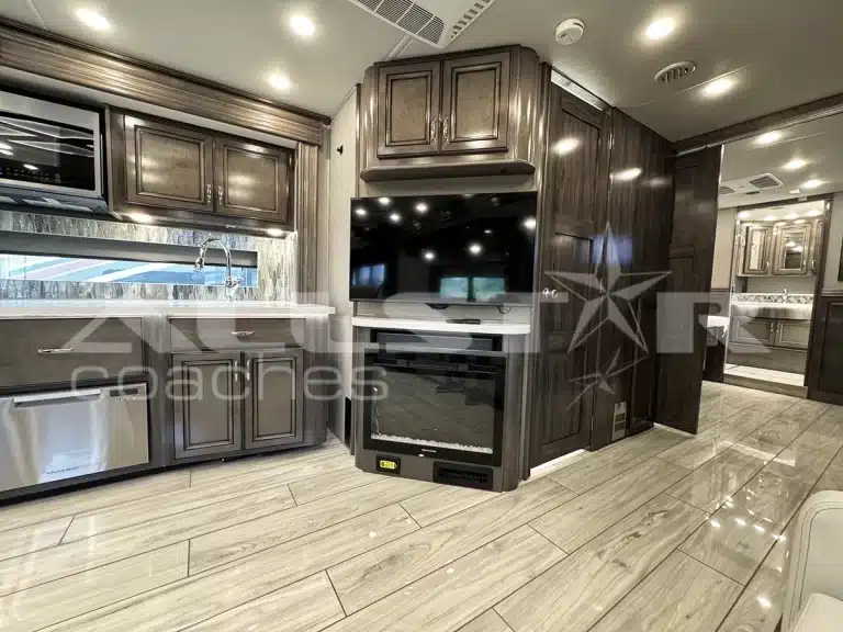 RV Rental: 40' Endeavor by Holiday Rambler - interior - kitchen and fireplace